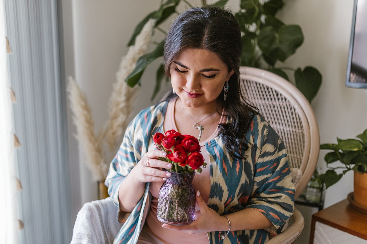 woman holding flowers in a vase