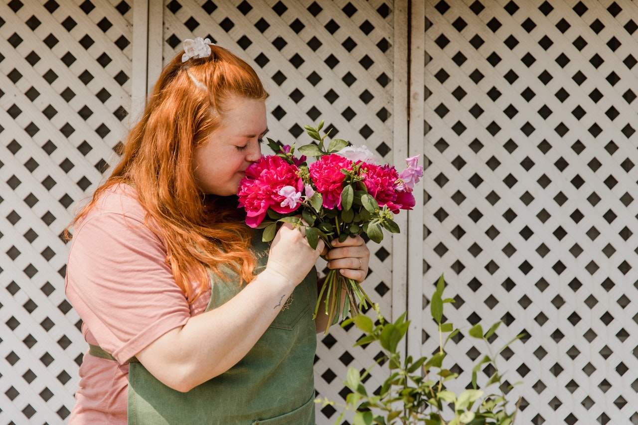 woman smelling flowers