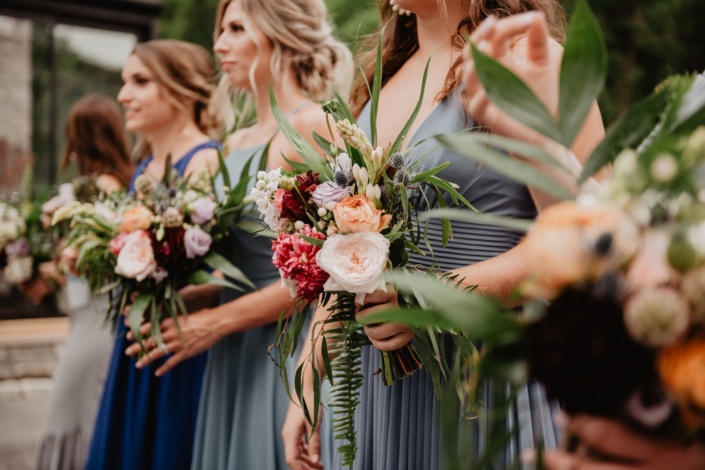 women holding wedding flowers